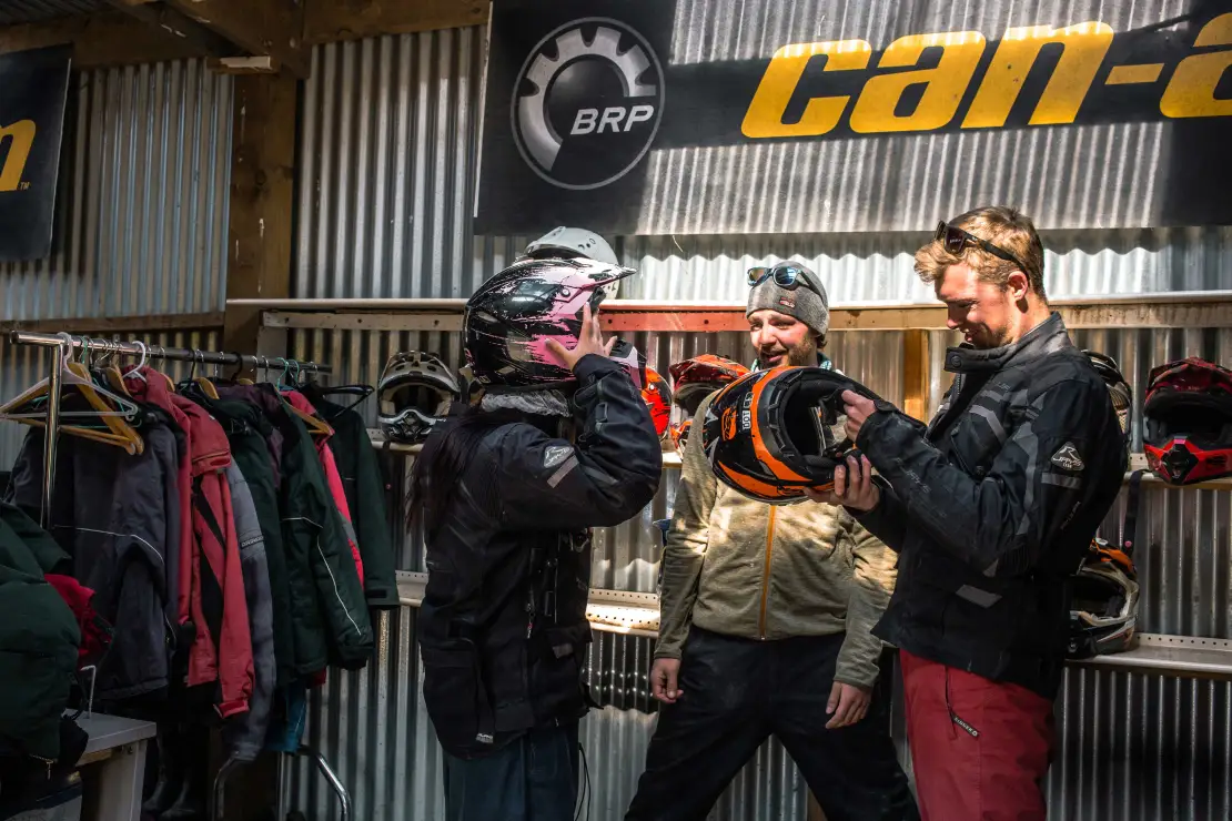 A group getting  to ride quad bikesready