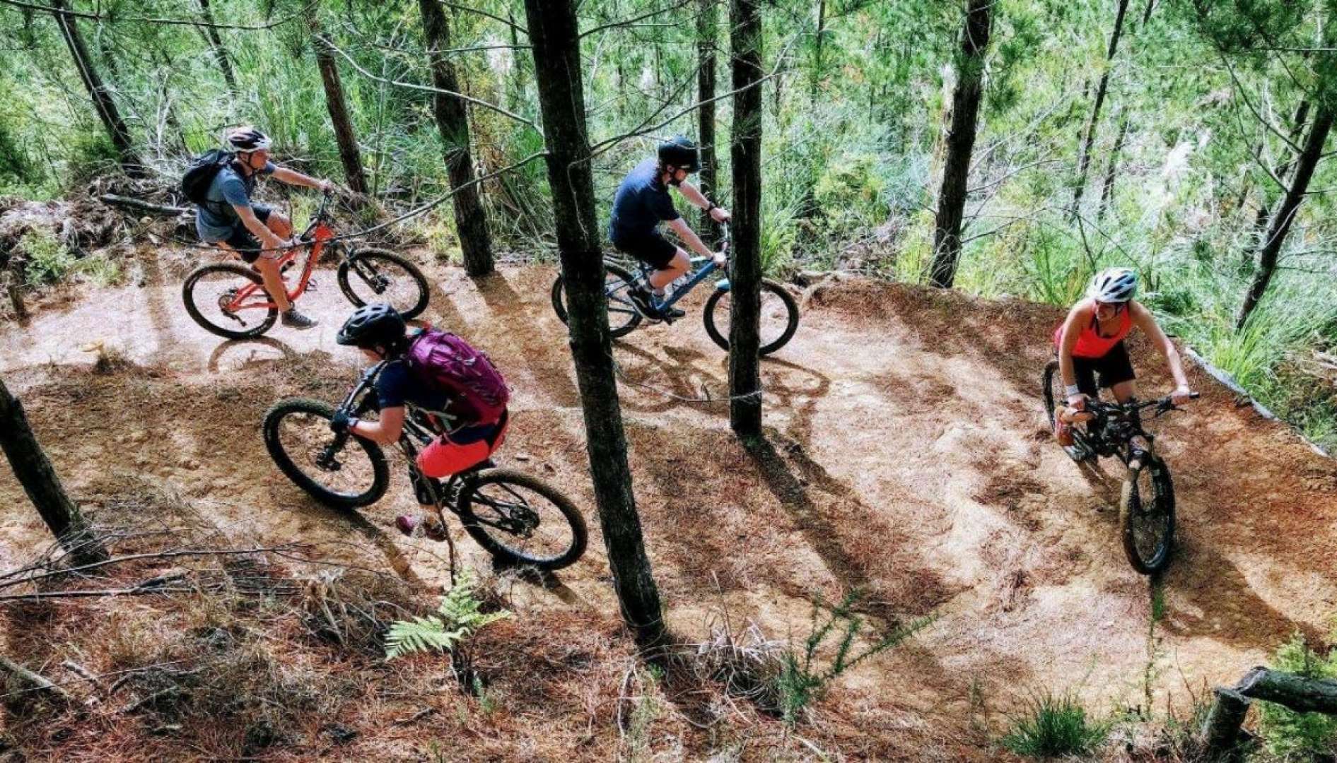 group biking through the waitangi mountain bike park track