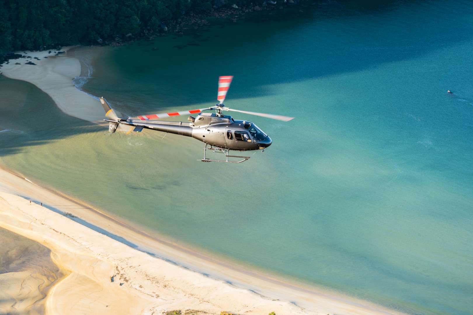 Helicopter Landing at remote beach Able Tasman South Island New Zealand