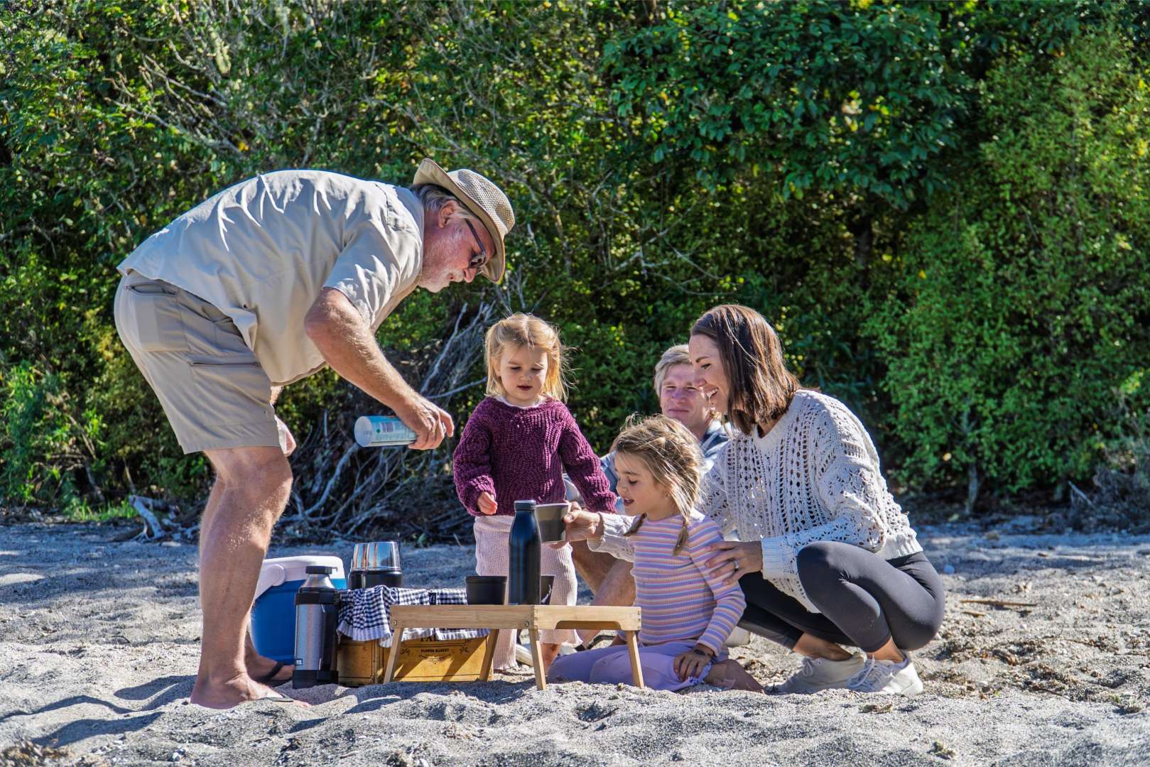 A family happily enjoying their lunch